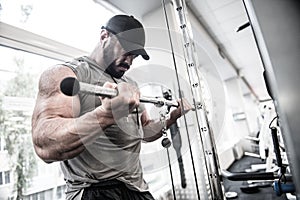 Sport mental mind concentration of strong young bearded man training big muscle using fitness equipment during heavy