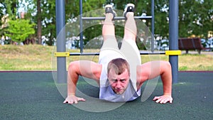 Sport motivation pushups from the floor. Young positive athlete does push-ups on the street spot spot. Healthy lifestyle