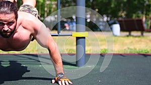 Sport motivation pushups from the floor. Young positive athlete does push-ups on the street spot spot. Healthy lifestyle