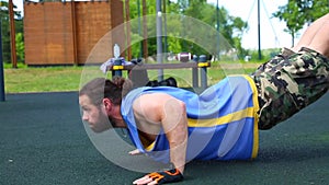 Sport motivation pushups from the floor. Young positive athlete does push-ups on the street spot spot. Healthy lifestyle