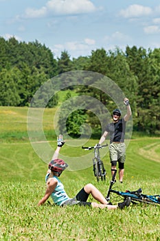 Sport mountain biking couple greeting in meadows