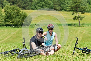 Sport mountain biking couple relax sunny meadows