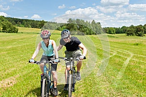 Sport mountain biking - man pushing young girl