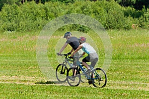 Sport mountain couple biking sunny meadows photo