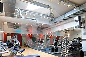 Sport - people exercising on machines in gym