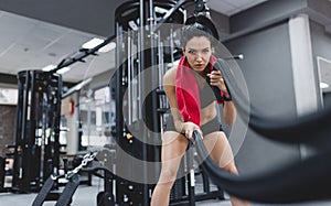 Sport, people, motivation concept. Fitness active brunette sportswoman working out in functional training gym doing crossfit