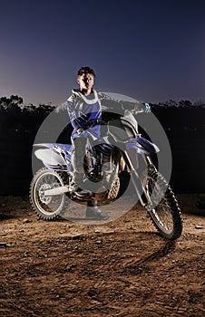 Sport, portrait and man with dirt bike, extreme confidence and gear for competition, race or challenge. Adventure