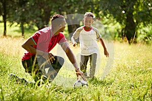 Sport Practice With Father Teaching Son How To Play Soccer