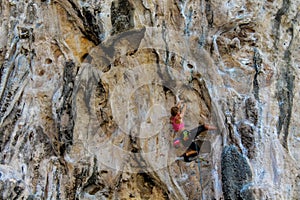 Sport rock climber on challenging climbing route in Ton Sai, Thailand