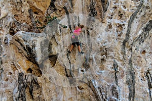 Sport rock climber on challenging climbing route in Ton Sai, Thailand