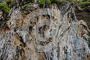 Sport rock climber on challenging climbing route in Ton Sai, Thailand