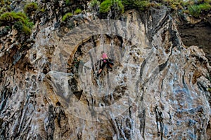 Sport rock climber on challenging climbing route in Ton Sai, Thailand