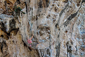 Sport rock climber on challenging climbing route in Ton Sai, Thailand