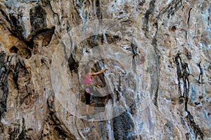 Sport rock climber woman on the wall in Ton Sai