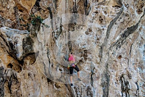 Sport rock climber woman on the wall in Ton Sai