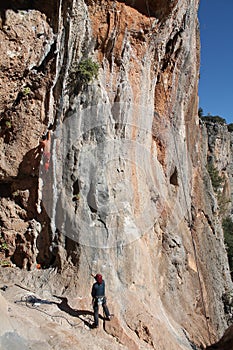 Sport rock climbing on natural rocks with stalactite