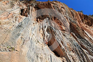 Sport rock climbing on natural rocks with stalactite