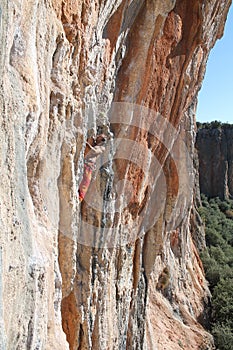 Sport rock climbing on natural rocks with stalactite