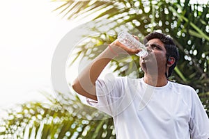 Sport runner black man wear athlete headphones he drinking water from a bottle
