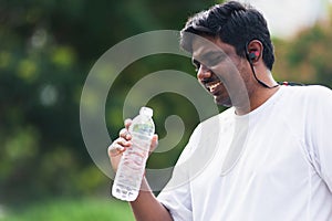 Sport runner black man wear athlete headphones he drinking water from a bottle