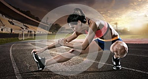 Sport. Runner stretching on the running track.