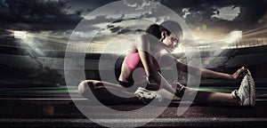 Sport. Runner stretching on the running track.