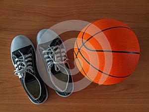 Sport shoes and basketball ball.