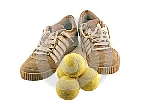 Sport shoes next to 4 tennis balls