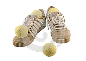 Sport shoes next to 4 tennis balls