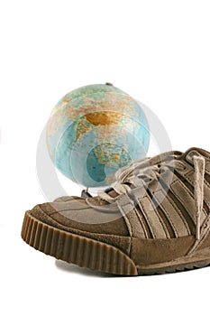 Sport shoes next to a globe