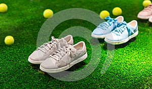 Sport shoes and tennis balls on a grass