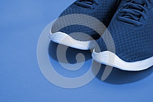 Sport sneakers on blue background with copy space for text. Sport objects background. Sports concept