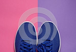 Sport sneakers on pink purple background with copy space for text. Sport objects background. Sports concept