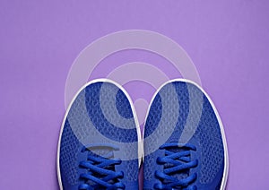 Sport sneakers on purple background with copy space for text. Sport objects background. Sports concept