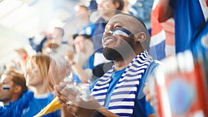 Sport Stadium Big Event: Handsome Black Man Cheering. Crowd of Fans with Painted Faces Cheer, Shout