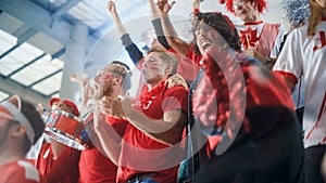 Sport Stadium Event: Crowd of Fans Cheer for their Red Soccer Team to Win. People Celebrate Scoring