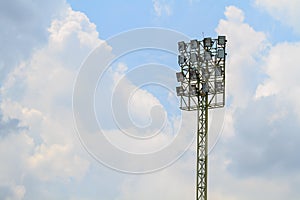 Sport stadium floodlights on a cloudy background.