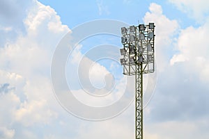 Sport stadium floodlights on a cloudy background.