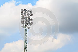 Sport stadium floodlights on a cloudy background.