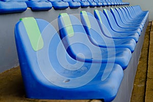 Sport stadium Plastic blue chairs in a row.