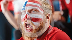Sport Stadium Sport Event: Portrait of Handsome Man with U.S. Flag Painted Cheering for Red Americn