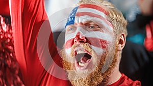 Sport Stadium Sport Event: Portrait of Handsome Man with U.S. Flag Painted Cheering for Red Americn