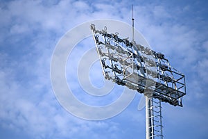 Sport stadium spotlight with blue sky background. Football and soccer light lamp