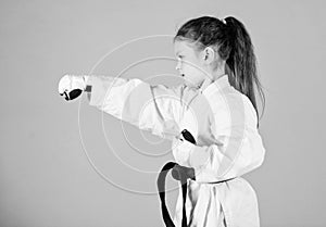 Sport success in single combat. practicing Kung Fu. happy childhood. little girl in gi sportswear. small girl in martial