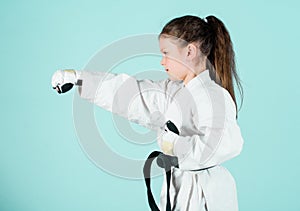 sport success in single combat. practicing Kung Fu. happy childhood. little girl in gi sportswear. small girl in martial