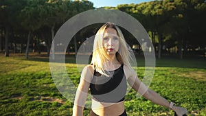 Sport training in city park. Beautiful caucasian fit woman outdoors