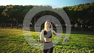 Sport training in city park. Beautiful caucasian fit woman outdoors