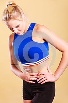 Fit woman suffering from stomach pain photo
