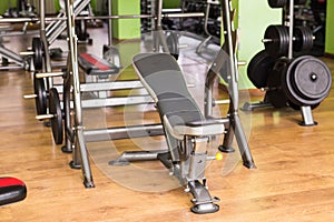 Sport, training and healthy lifestyle concept - gym interior with equipment.