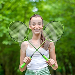 Sport woman with badminton rackets